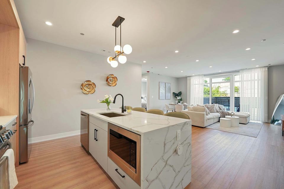 Well-lit kitchen island that anchors the space for prep, snacks, or morning coffee.