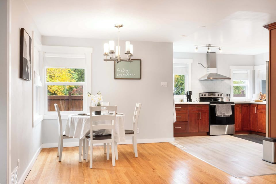 Airy flow between dining, living, and kitchen makes gathering easy and enjoyable.