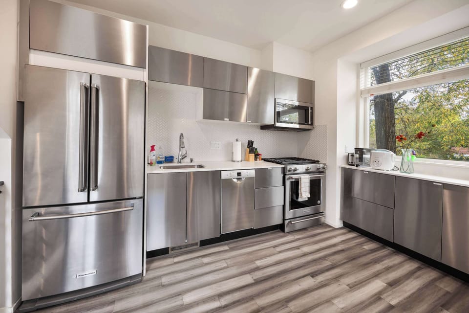 Step into the heart of our home—a sleek, modern kitchen designed for both style and functionality. Featuring premium stainless steel appliances, including a spacious French-door refrigerator, a gas range, and a built-in dishwasher.