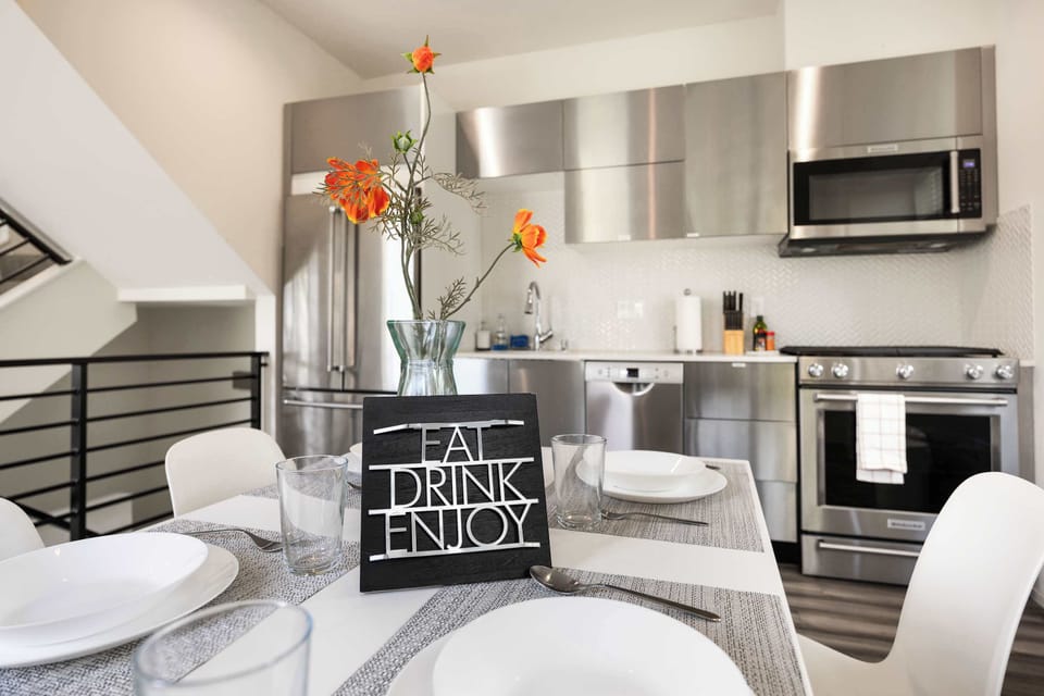 Welcome to a dining space that blends modern elegance with warmth and comfort. This bright and airy area sits adjacent to a state-of-the-art kitchen, making it easy to transition from preparing meals to enjoying them with friends and family. 