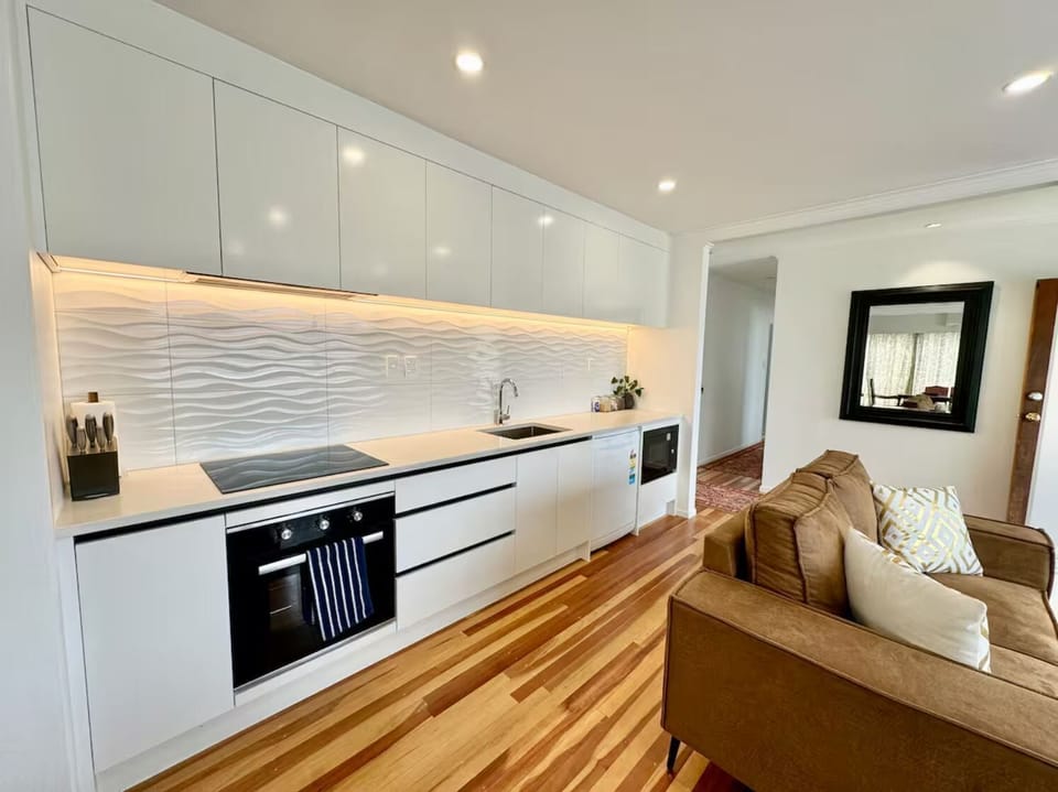 Modern kitchen with full appliances and open layout to living area.