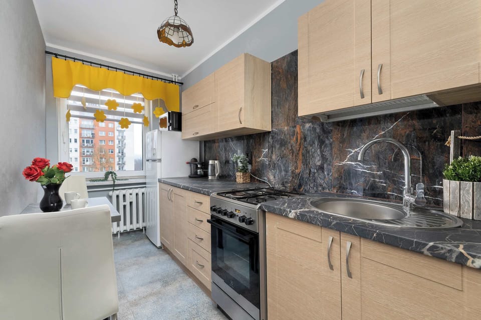 The bright kitchen with wooden cabinetry provides a comfortable spot for cooking, and the window view makes enjoying your morning coffee even more pleasant.