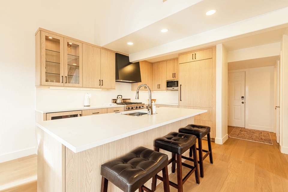 Modern kitchen with large island and bar seating.