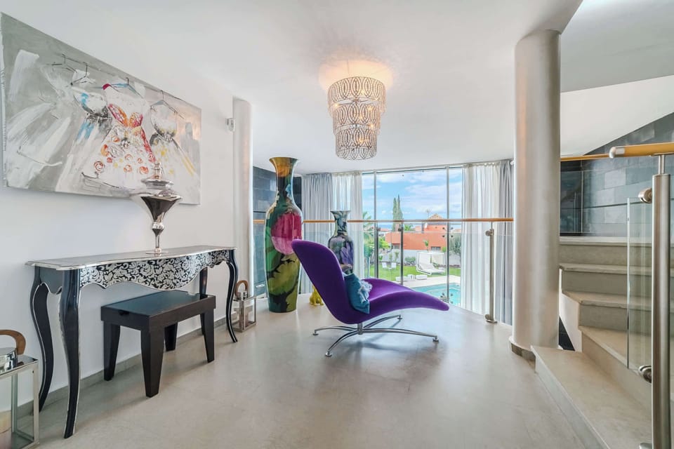 Artful Upper-Level Lounge with Statement Design - A Bold and Bright Spot to Read, Relax, or Enjoy the Pool View
