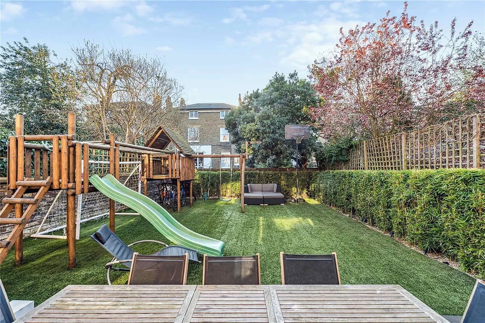 Step outside into your private garden oasis, complete with a playground for the little ones.