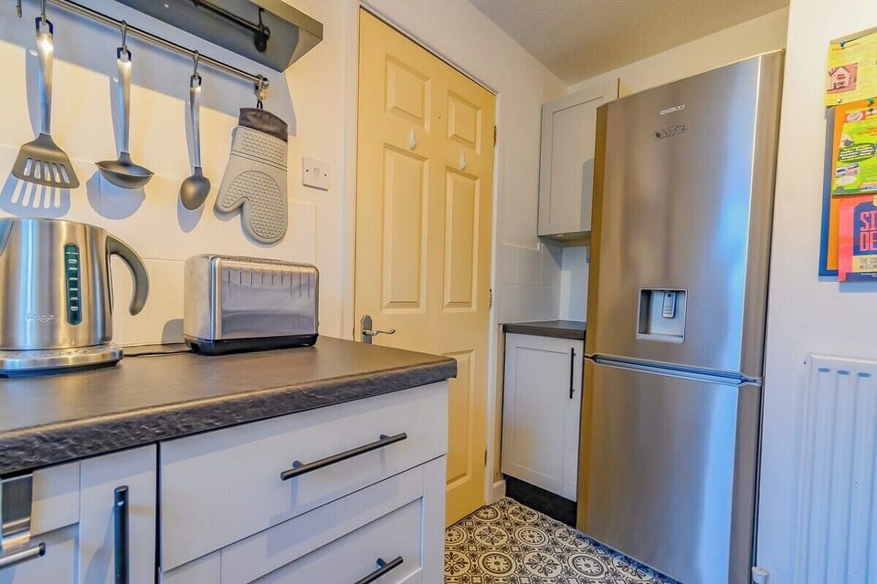 Modern appliances including oven, stove, microwave, and fridge.

