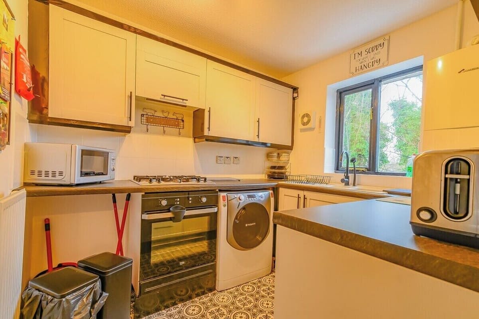 Fully equipped kitchen with oven, stove, microwave, and all cooking essentials.