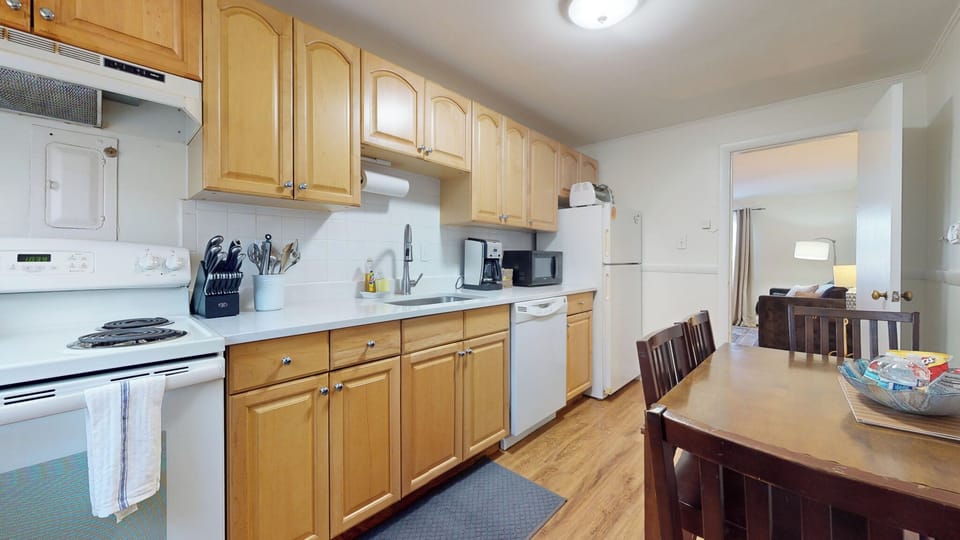 
sunlit eat in kitchen equipped with cookware