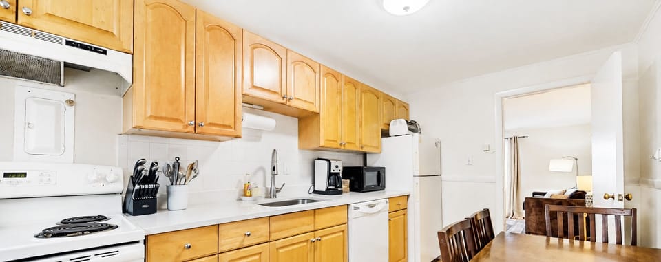 Kitchen is equipped with lots of storage spaces and ready to use appliances. Dining table sits 4.