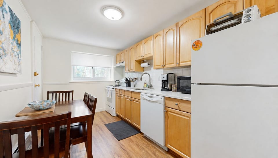 sunlit eat in kitchen equipped with cookware