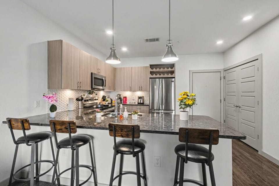 - Gourmet kitchen with granite countertops and bar seating - Stainless steel appliances microwave oven and dishwasher - Open layout ideal for cooking dining and entertaining guests