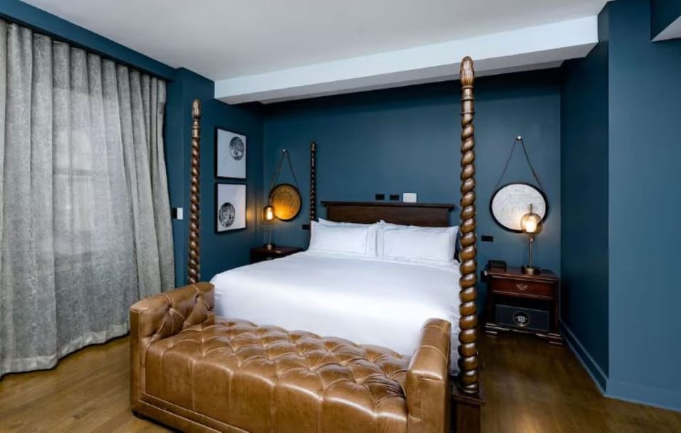 Indulge in a dramatic four-poster bed for a boutique stay.