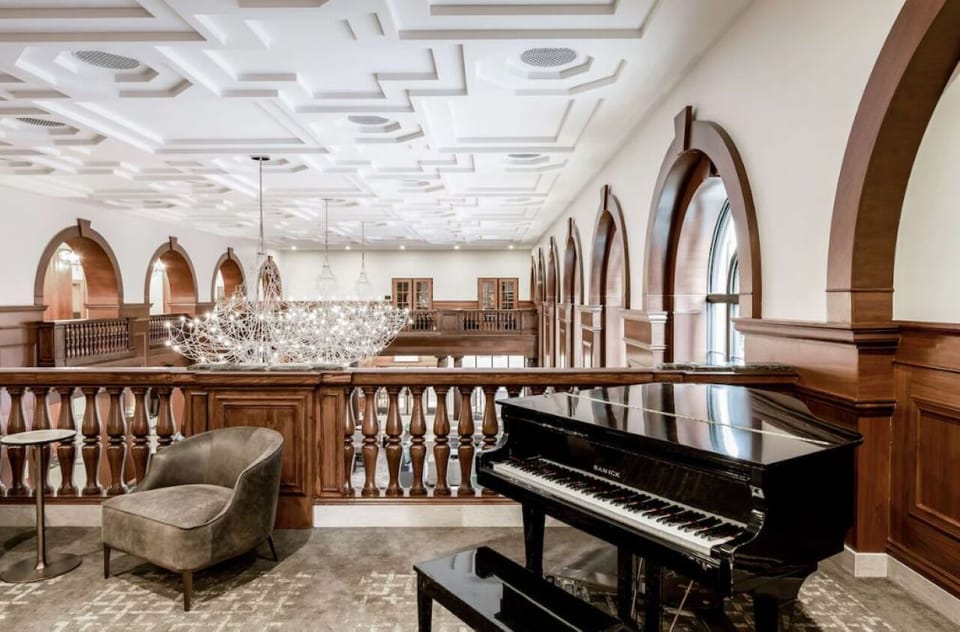 Unwind beneath soaring ceilings beside the elegant grand piano.