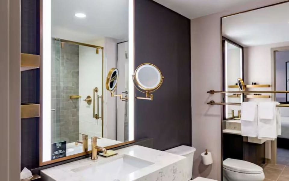 Refresh effortlessly in a bright bath with chic brass accents.