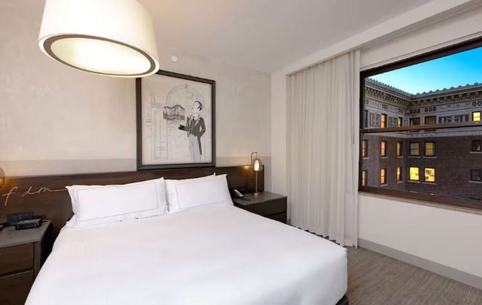 Unwind in crisp linens with calming city views.