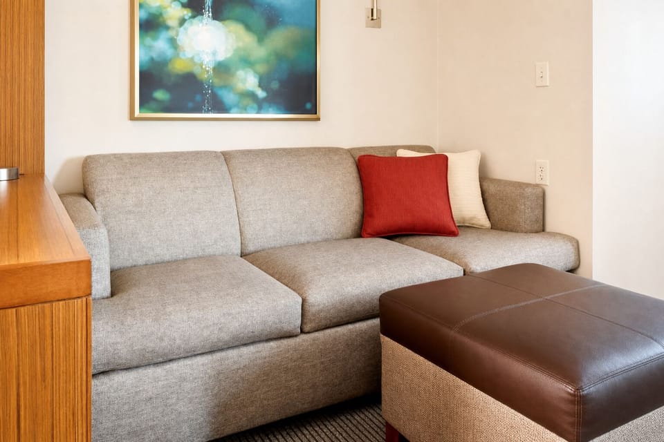 Relax on the inviting sofa with soft textures and calm tones.