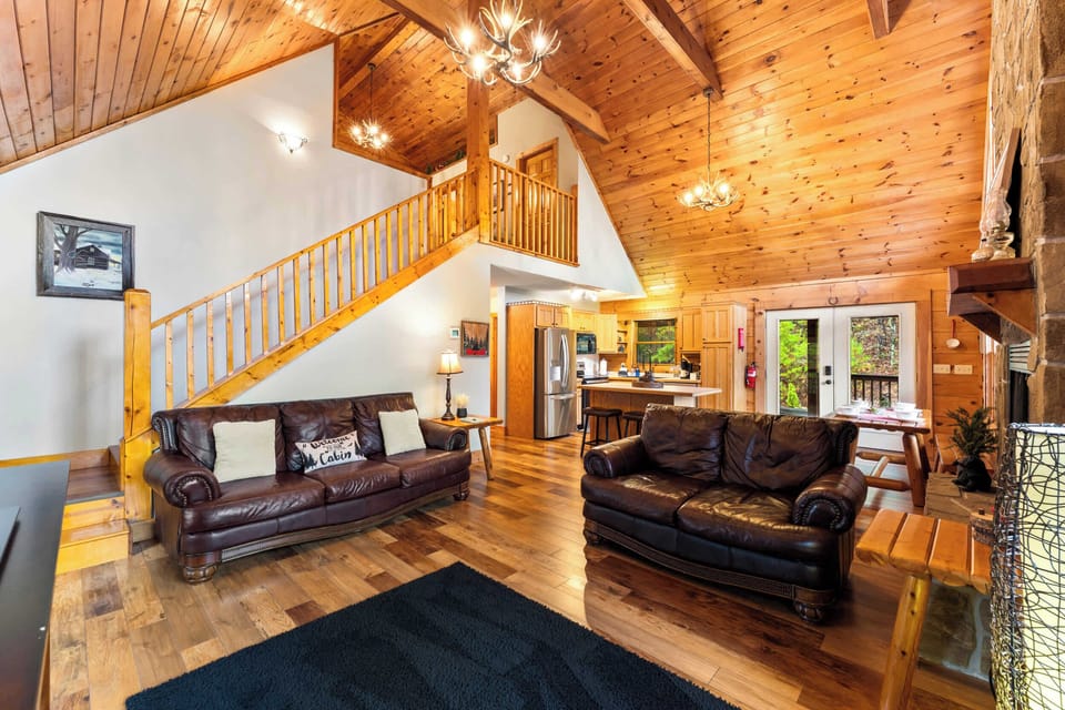 Bright, open-plan living, kitchen, and dining with stunning cabin charm