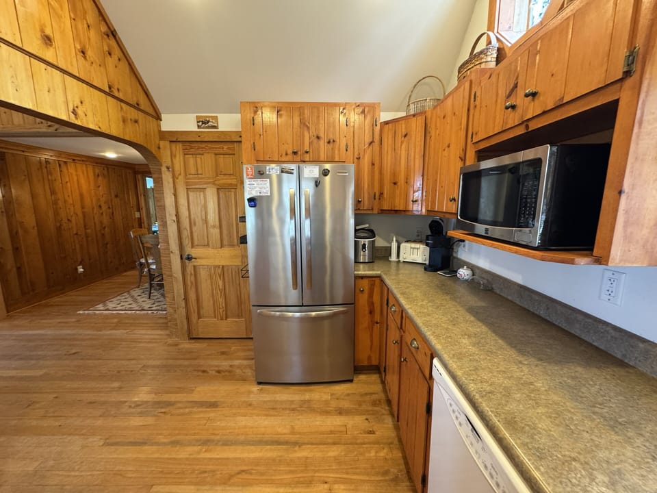 full fridge, microwave, ice maker, coffee maker, and toaster