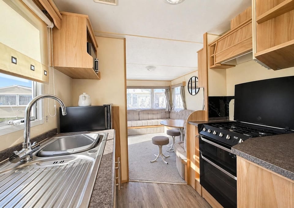 The lounge opens onto the kitchen so it is easy to keep the family full with snacks during a cosy movie night in in this modern Essex coast caravan.