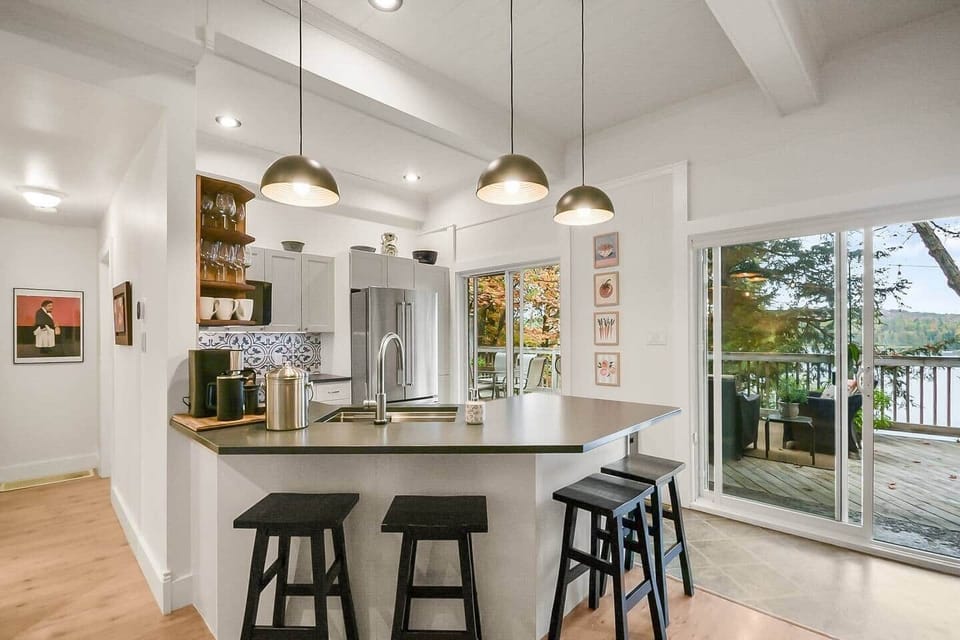 There is a generous amount of prep space that faces out into the living room and dining room. There are 4 bar stools that tuck under the counter.