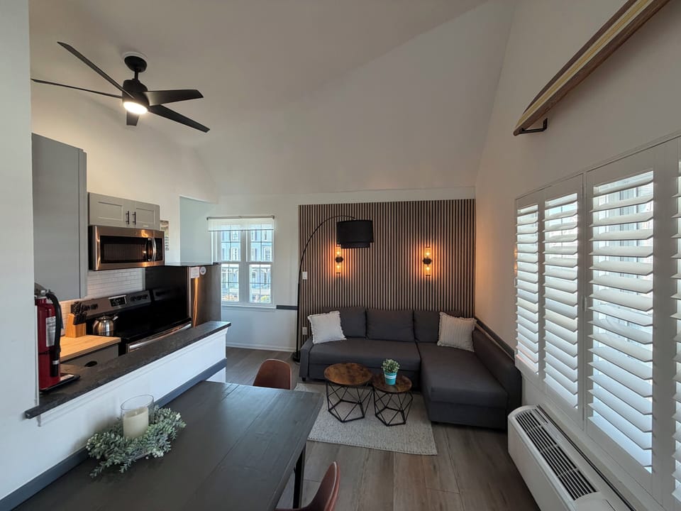 Bright modern lounge with vaulted ceilings and a cozy sectional