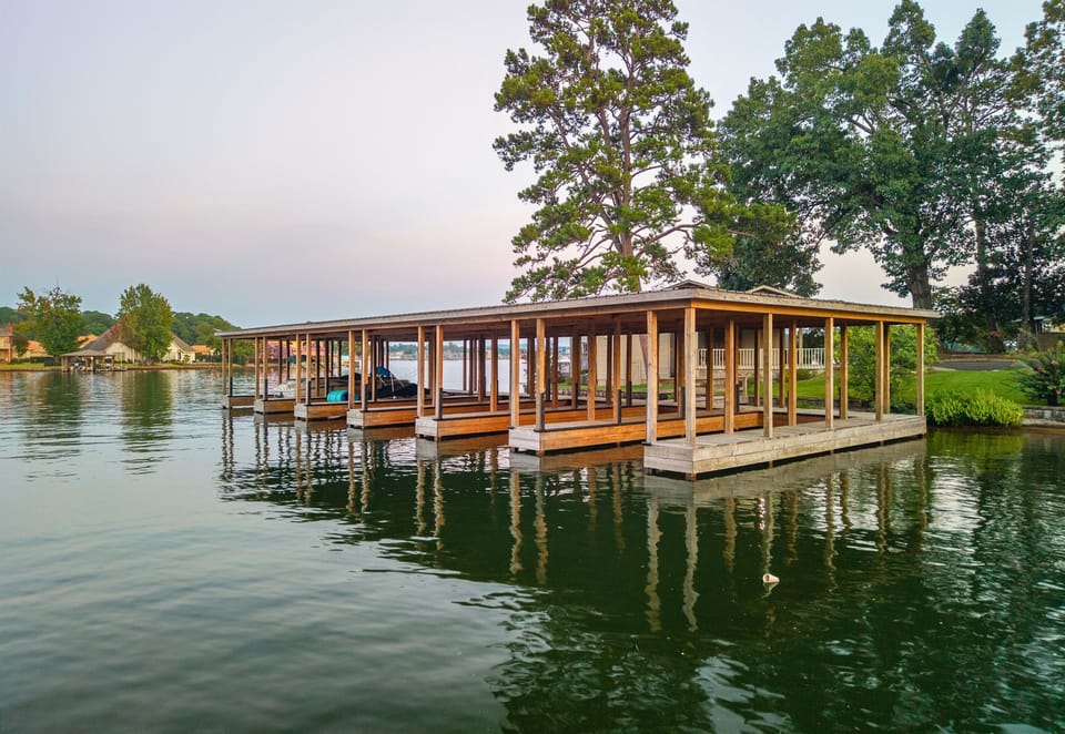 Private dock with covered boat slip on the water.