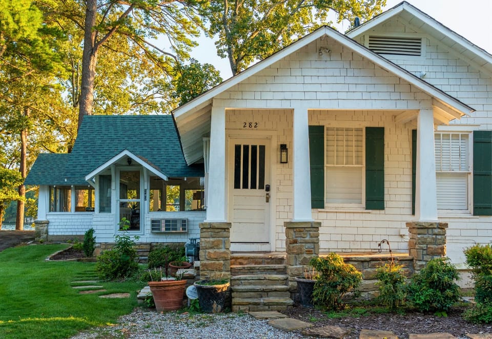 Charming cottage entrance with classic lake house vibes—welcome to your lakeside getaway!