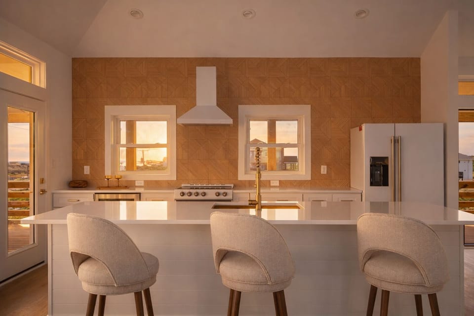 Enjoy bar top seating on the white quartz island with ocean views