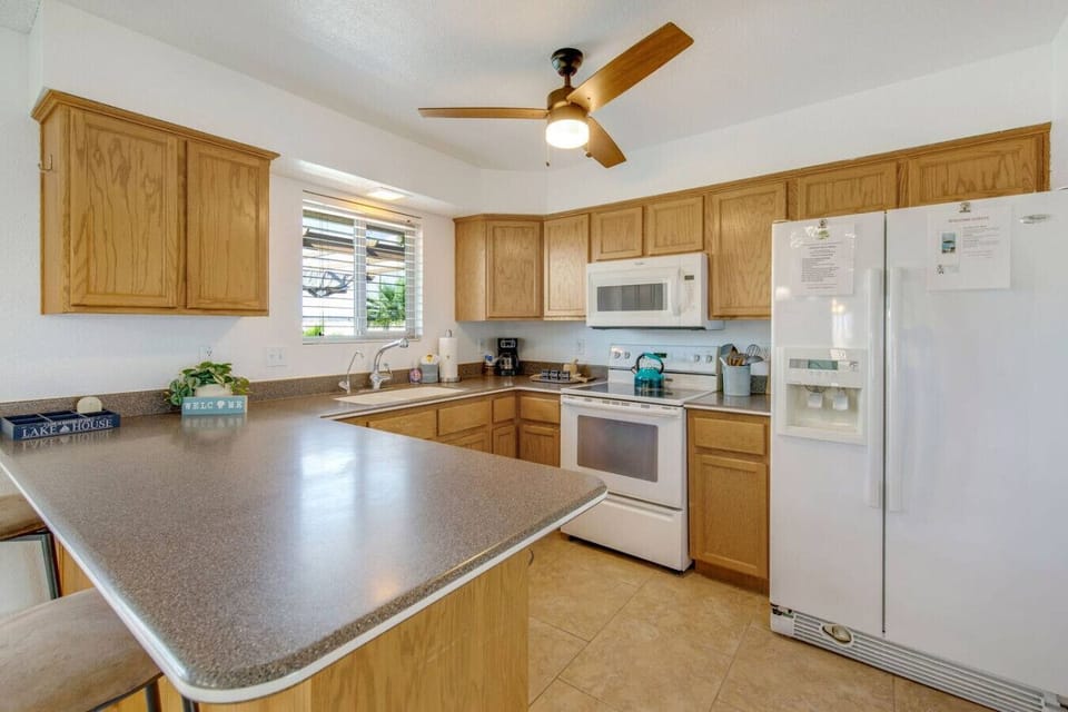 Fully equipped kitchen with ample counter space, island seating, and modern appliances.