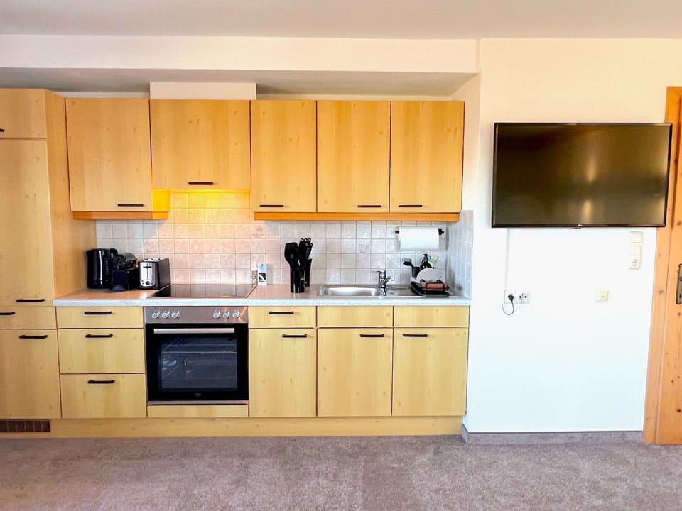 Furniture, Kitchen, Wood, Cabinetry, Flooring, Interior Design, Countertop, Kitchen Appliance, Floor, Major Appliance