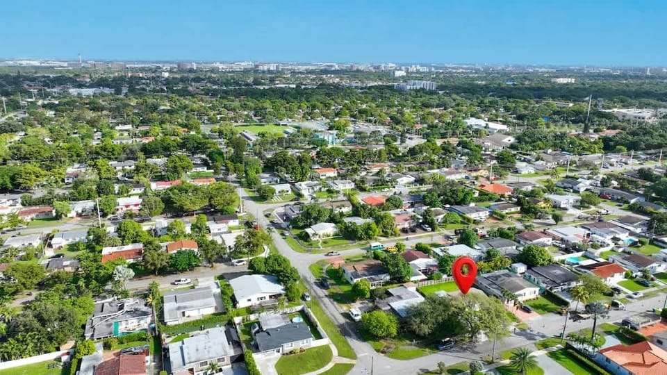 This aerial photo highlights the property's location within a larger neighborhood and its proximity to a city skyline.