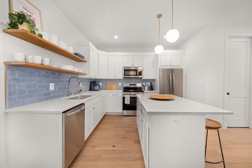 Floating wood shelves and designer backsplash - thoughtful details throughout