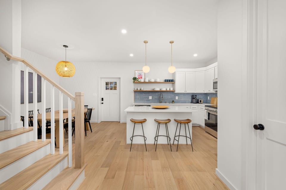 Gourmet kitchen with coastal blue subway tile backsplash and island seating