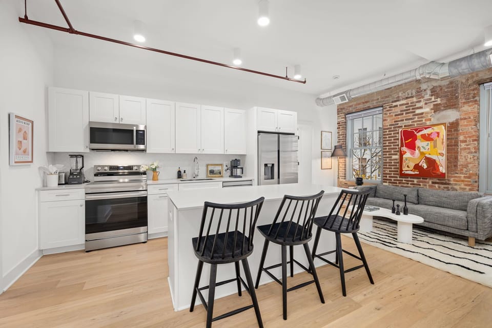 Chef's kitchen with stainless appliances and breakfast bar