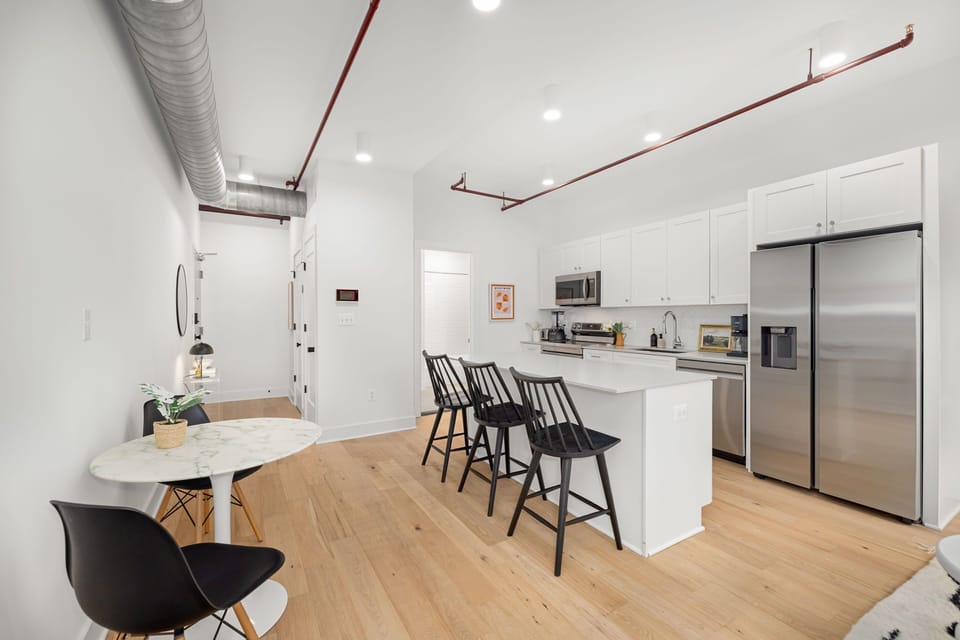Dining area with exposed ductwork and hardwood floors