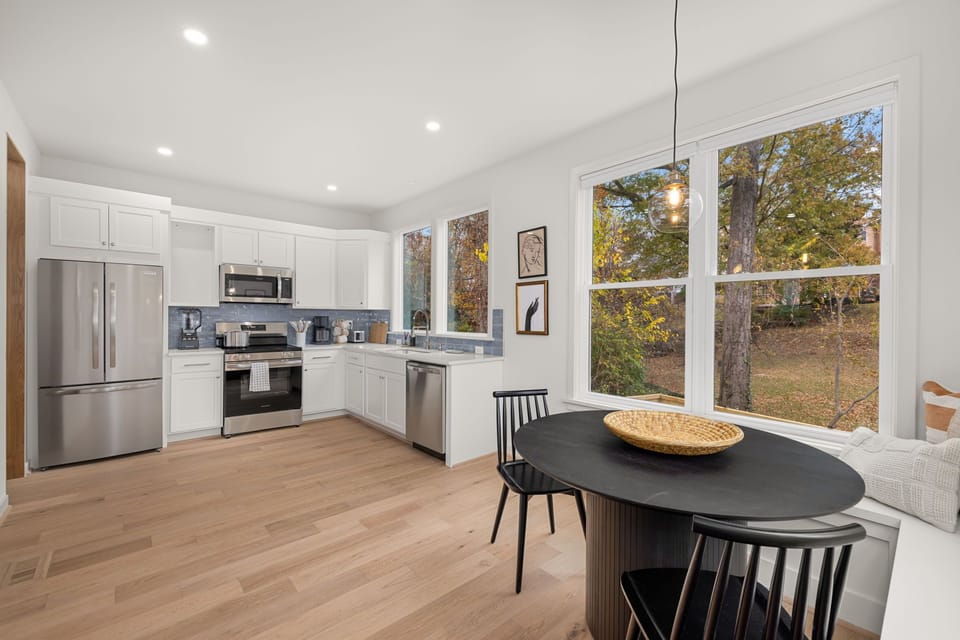 Modern kitchen with stainless steel appliances and blue tile backsplash