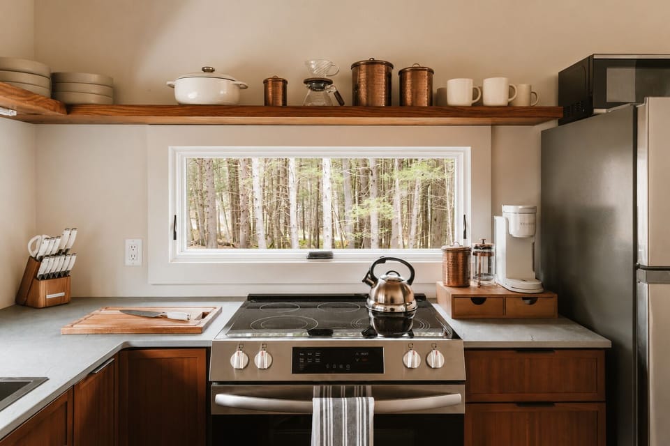 Boil water in the kettle for tea or use the knife set on the board for chopping. The stove has plenty of burners going if you're cooking for the group, plus a Keurig on the side for quick coffee.