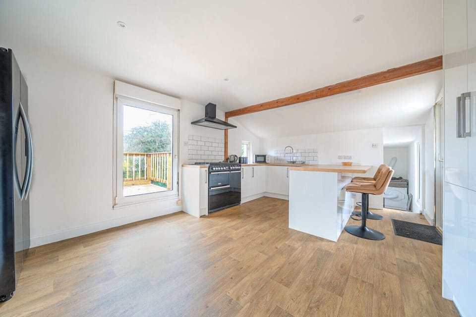 Bright kitchen and dining area with outdoor views.