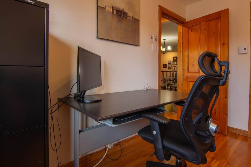 Dedicated workspace with desk and ergonomic chair.