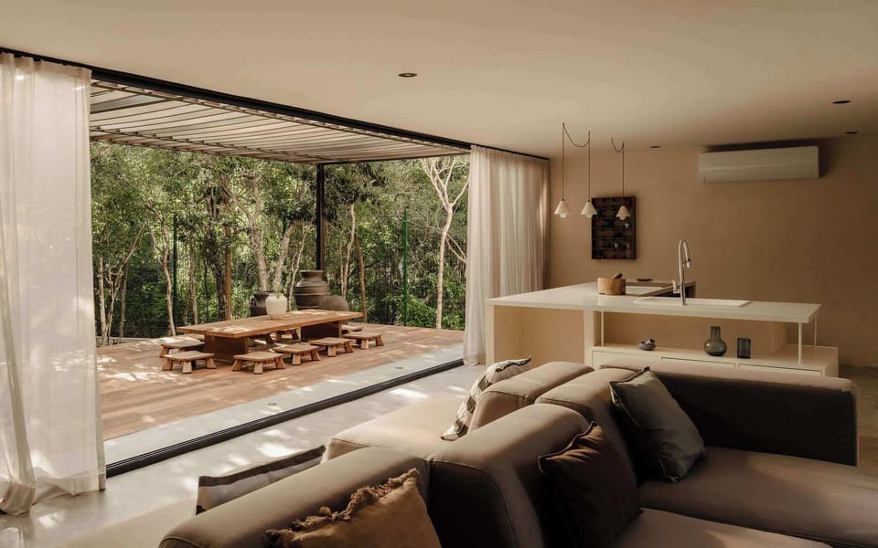 Casual living space with layered textures and tropical views.
