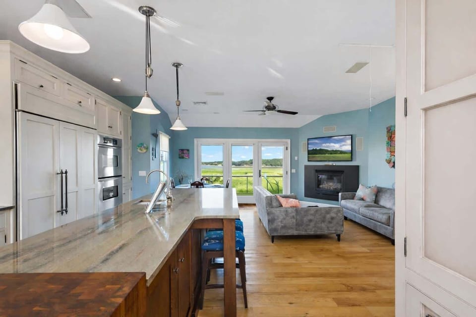 Another angle of the open-concept living and dining space, showcasing natural light and easy flow to the deck.