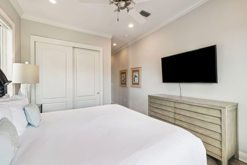 Your elegant bedroom features a plush bed, smart TV for entertainment, and stylish furnishings creating the perfect retreat.