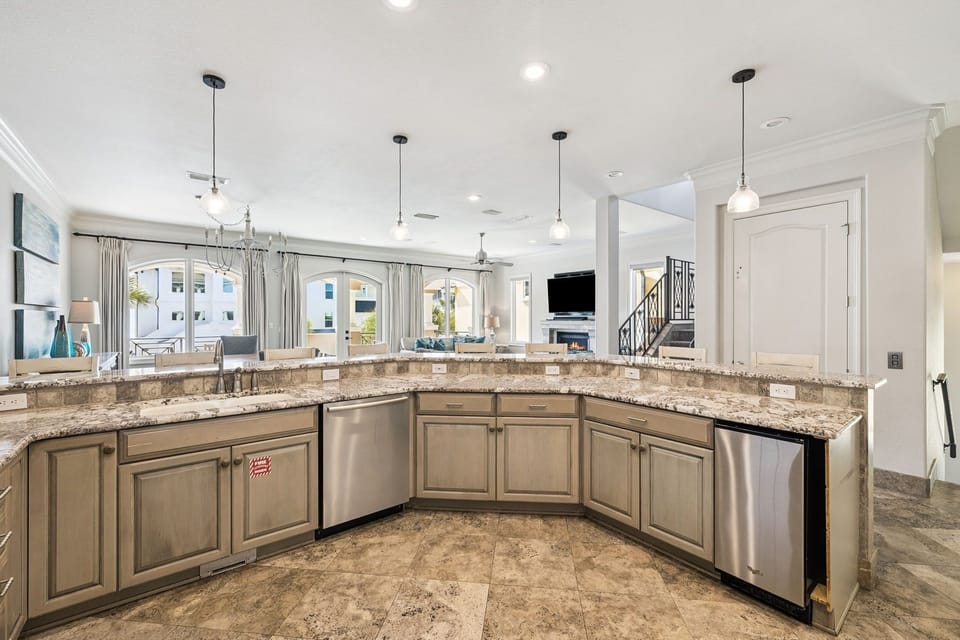 Your spacious open kitchen features granite countertops, stainless appliances, and pendant lighting flowing into the bright living area.