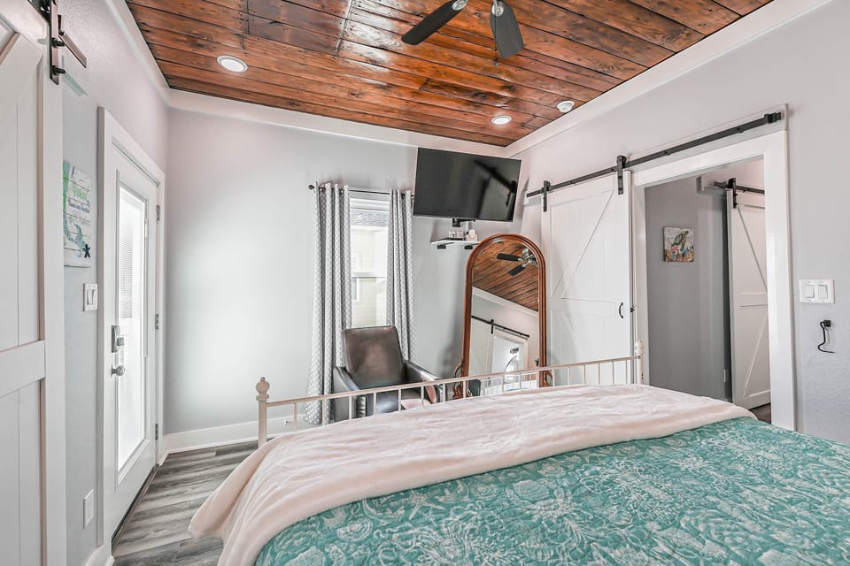 The bedroom has a full-length mirror and flat-screen TV that uses Roku streaming.