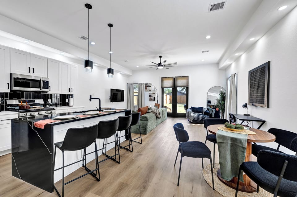 Dining Area & Breakfast Bar | 1st Floor | Dishware/Flatware