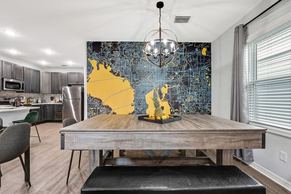 The standout wall map adds character to this contemporary dining/game area, making it a memorable spot for every guest.