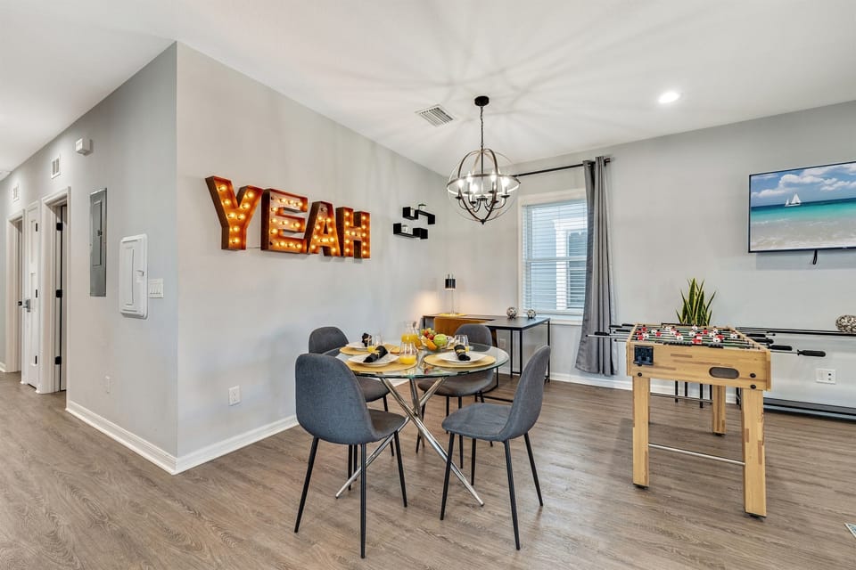 This versatile space features a cozy dining setup alongside entertainment options, creating the perfect social hub.