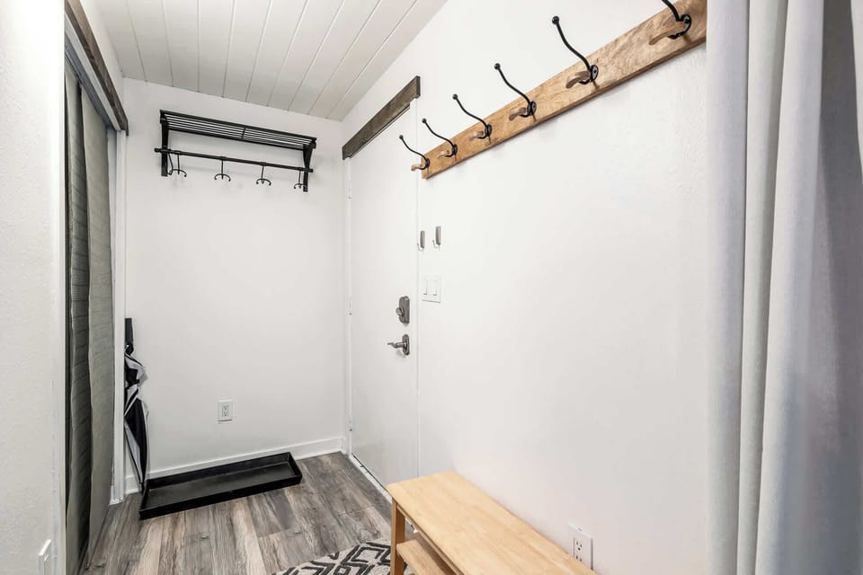Entryway with closet and coat storage