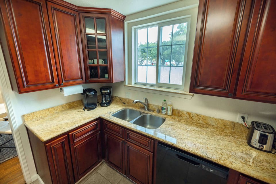 Gather and create in this inviting kitchen complete with ample storage, bright natural light, and everything you need for effortless home cooking