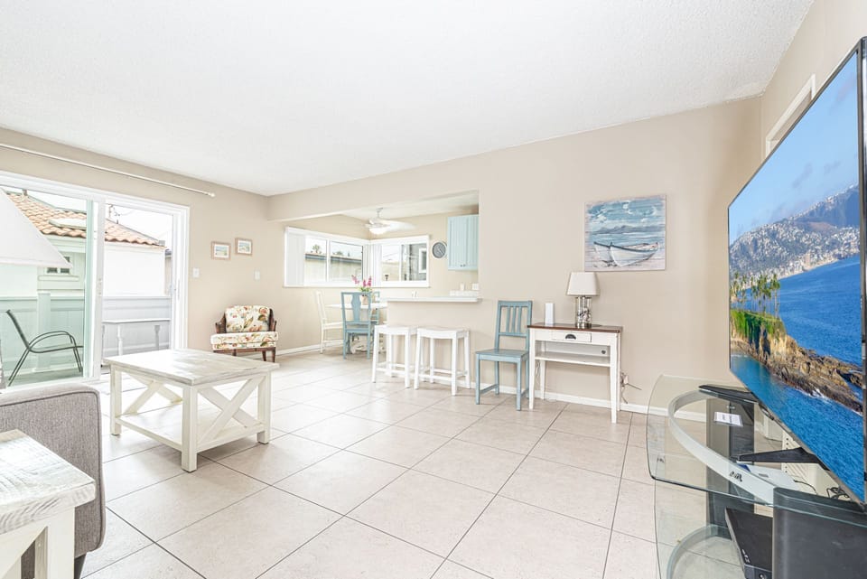 Main living spaces looking from front entry area. Open floor plan between living, kitchen and dining areas.
                